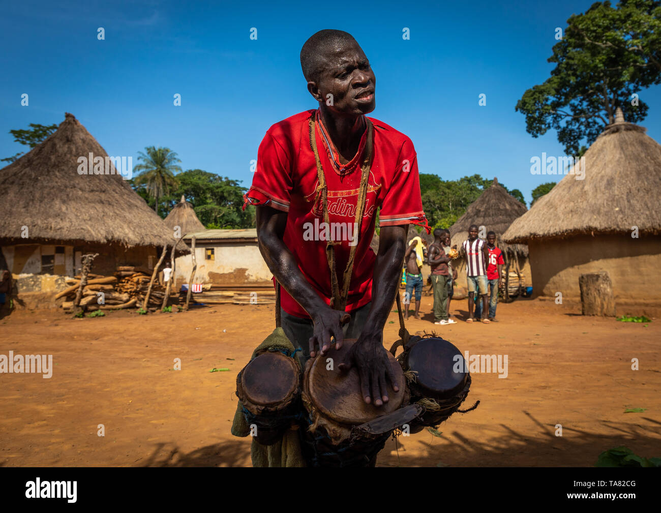 Dan tribe uomo battendo i tamburi durante una cerimonia, Bafing, Gboni, Costa d'Avorio Foto Stock
