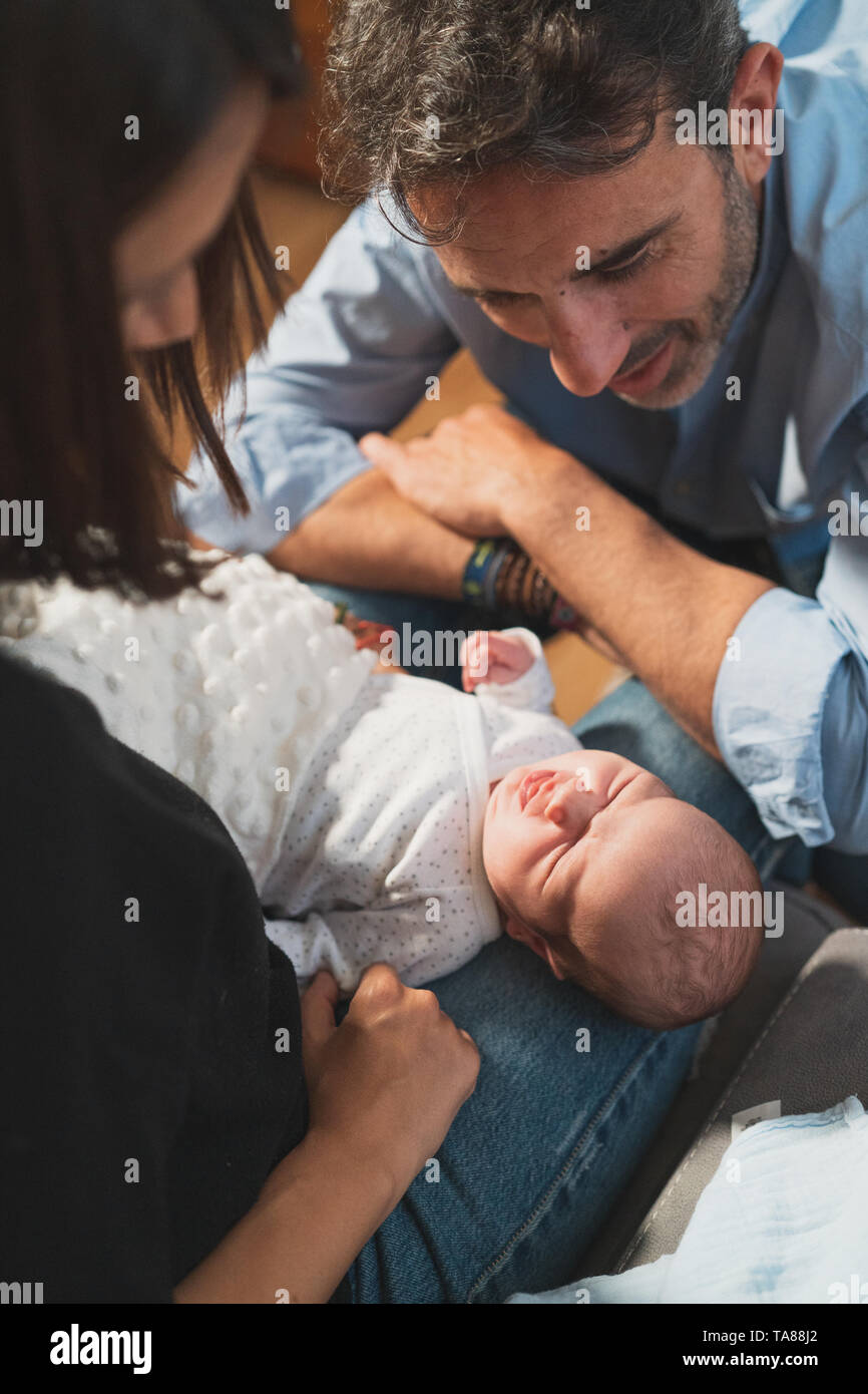 Vista dall'alto di un simpatico adorabile bambino dorme con le braccia aperte sulla sua madre e suo padre. Famiglia, vita nuova, infanzia, inizio concetto. Foto Stock