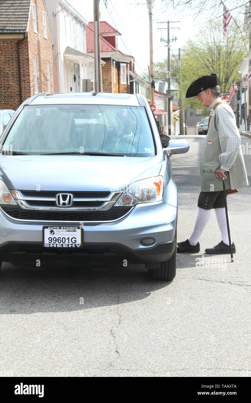 Uomo in abbigliamento coloniale vicino al veicolo moderno nel centro di Annapolis, MD, Stati Uniti d'America Foto Stock