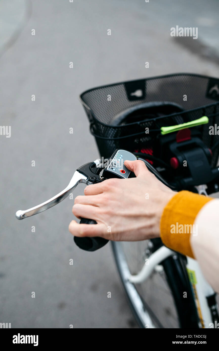 Close-up di donna su e-bike che collega il motore elettrico Foto Stock