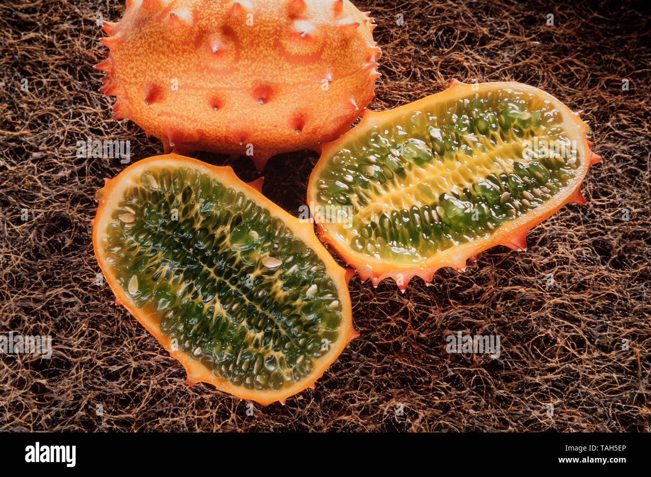 African cornuto melone, 'Kiwano' Cucumis melo, pelle esterna e interna flash di colore verdastro. Foto Stock