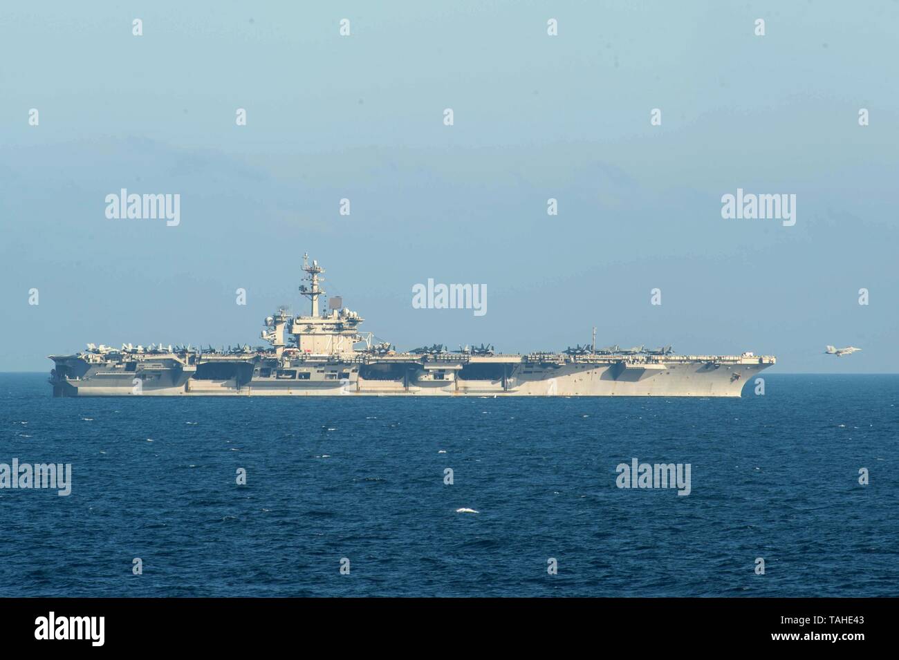 Un U.S. Navy F/A 18 Super Hornet fighter aircraft lancia fuori dalla prua della Nimitz-class portaerei USS Abraham Lincoln durante le operazioni 21 maggio 2019 nel Mare Arabico. La portaerei è parte delle forze aggiuntive essendo inviato per il Medio Oriente per contrastare ciò che Trump gestione chiamate chiare indicazioni di minacce dall'Iran. Foto Stock