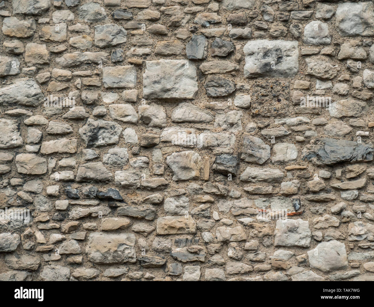 La texture di un muro di pietra da vicino Foto Stock