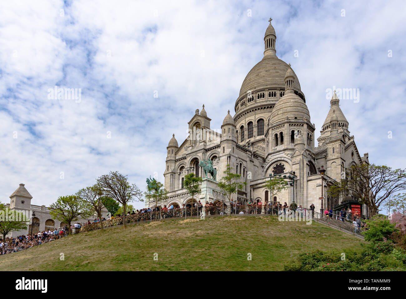 I turisti affollano dalla riga nella parte anteriore del Sacré-Coeur basilica in un giorno di primavera Foto Stock