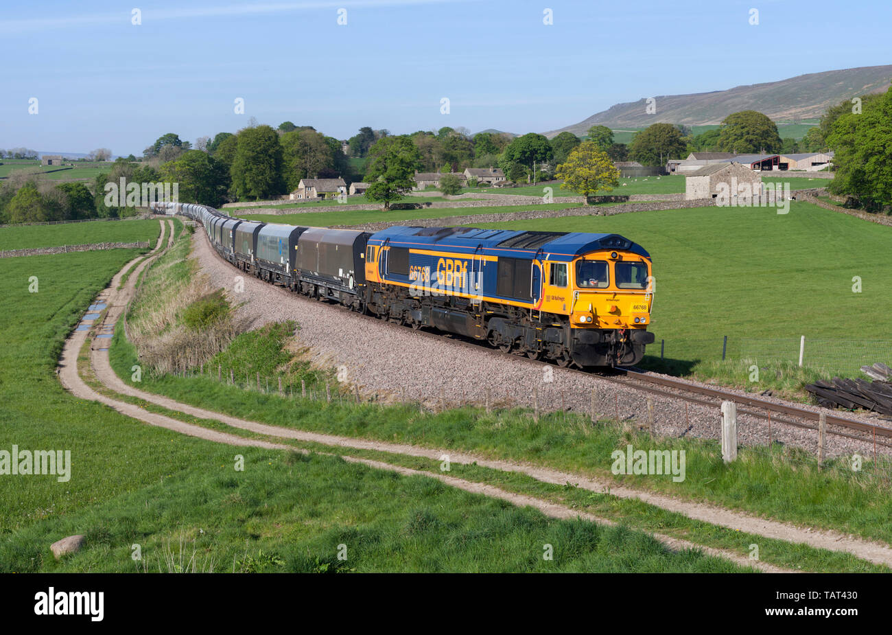 GB classe di merci su rotaie 66 66768 locomotiva trasporta un treno sulla Scenic linea di trasporto merci di Rylstone cava, a nord di Skipton, Yorkshire portando la pietra. Foto Stock