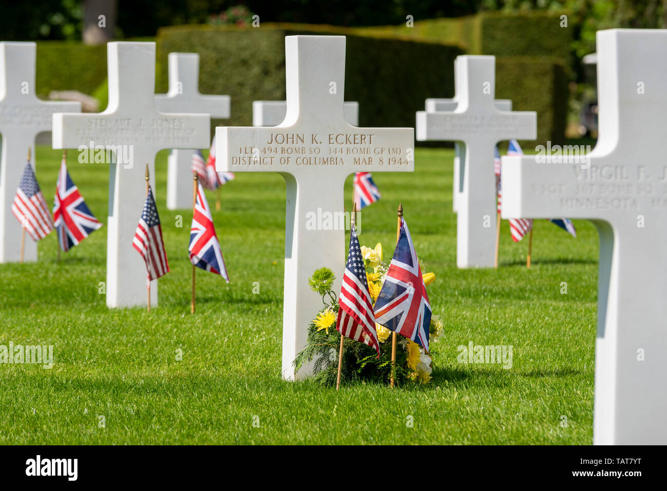 Cross lapide di Giovanni K Eckert e fiori a noi il Memorial Day ricordo evento presso Cambridge American Cimitero e memoriale, Cambridgeshire, Regno Unito. Foto Stock