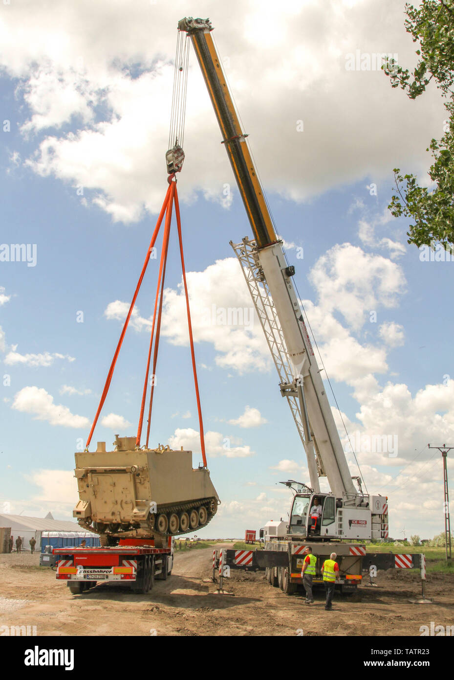 Una gru di offload un M1068 integrato standard Command Post System (SICPS) il vettore assegnato al primo battaglione, sedicesimo Reggimento di Fanteria, 1° Brigata corazzate contro la squadra, 1a divisione di fanteria in base fuori di Fort Riley, Kansas al Smardan Area Formazione, Romania, 22 maggio 2019. Il ferro Rangers partecipano a corsi di formazione multinazionale con esercizi di alleato e partner le forze armate per migliorare la prontezza di aumentare l'interoperabilità e rafforzare il legame tra le nazioni (U.S. Foto dell'esercito da Staff Sgt. Vero Thao) Foto Stock