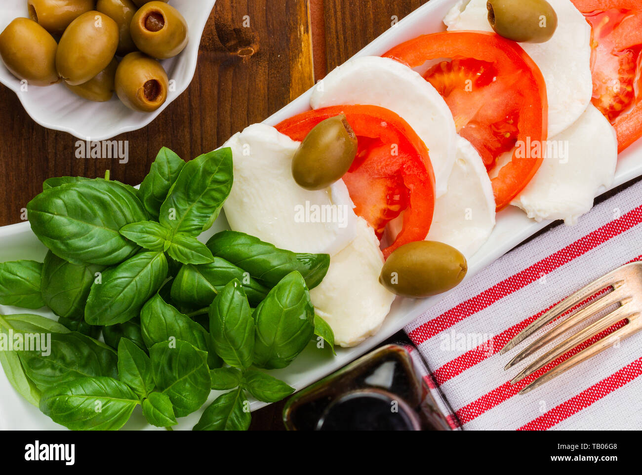 Mozzarella Fresca e pomodori e basilico. Pasto vegetariano. Cucina Italiana. Colori italiani. Foto Stock