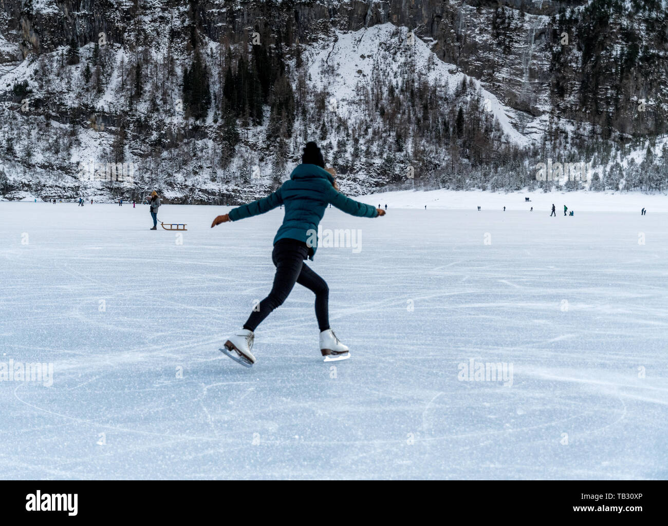 Pattinaggio sul ghiaccio congelato sul lago Oeschinensee in Berner Oberland Foto Stock