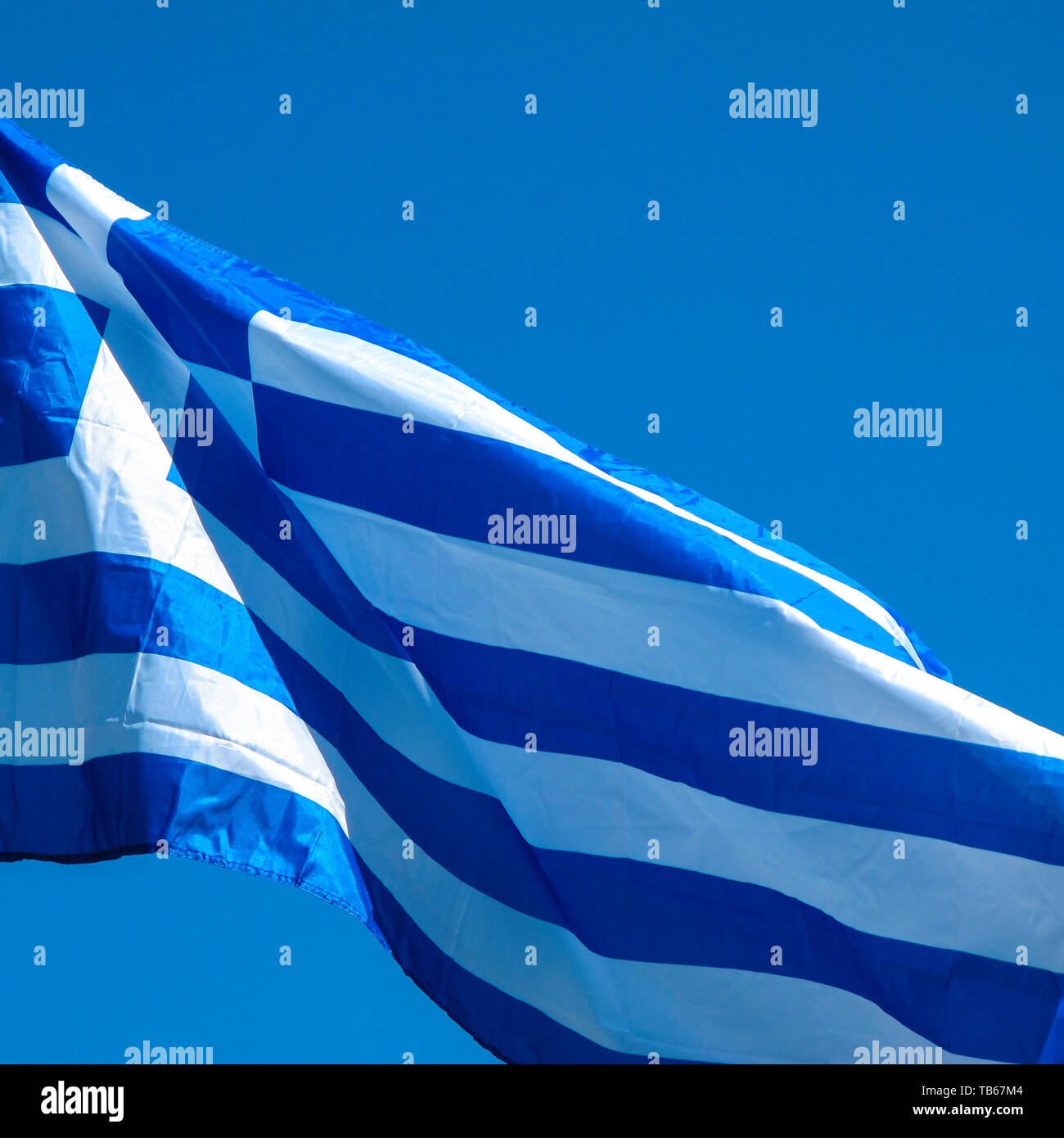 Bandiera Greca contro un azzurro cielo Mediterraneo Foto Stock