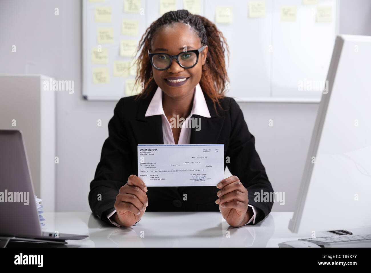 Close-up di un sorridente imprenditrice che mostra azienda verificare Foto Stock