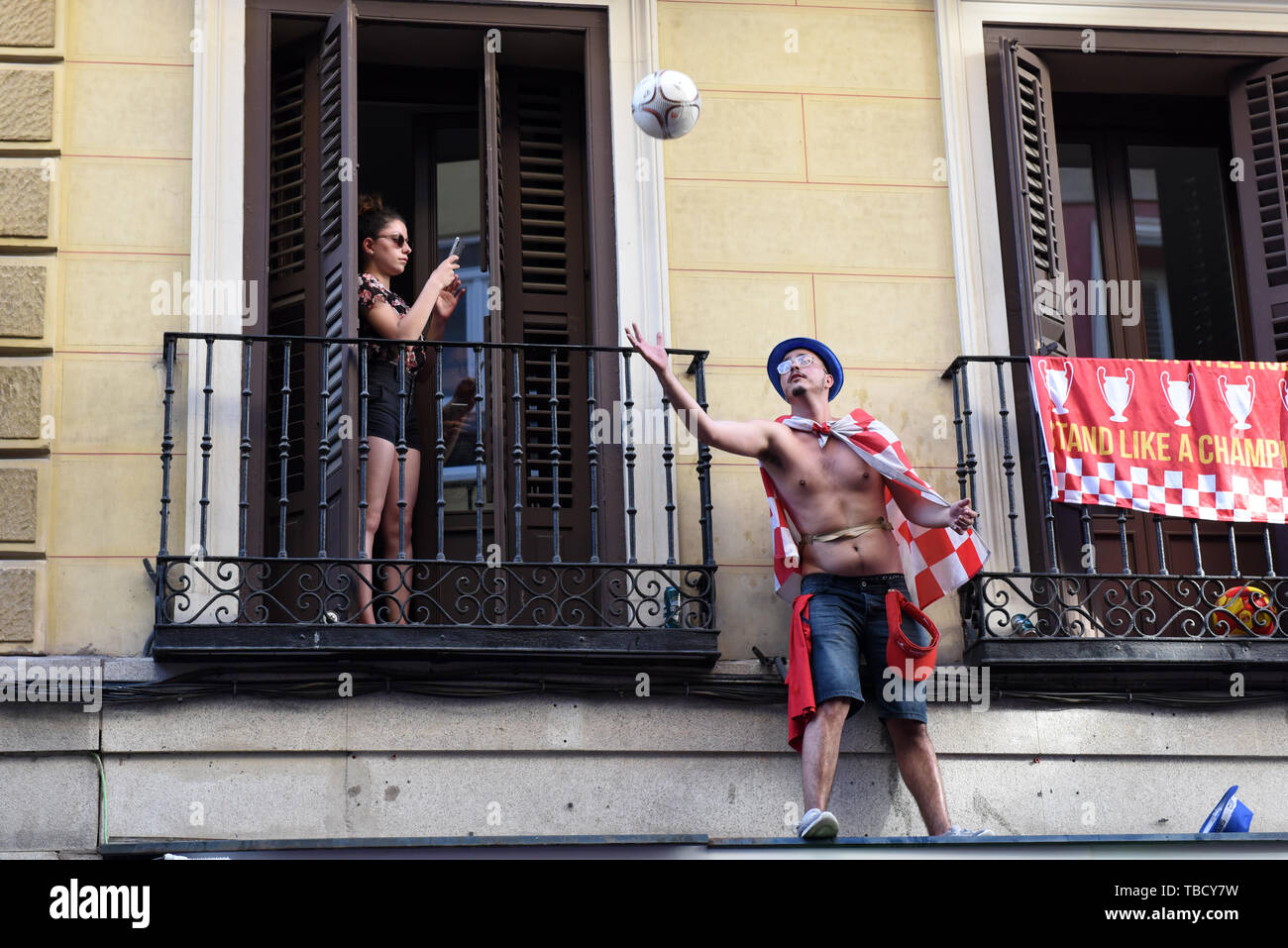 Una donna prende la foto di un ventilatore di Liverpool giocando con una palla nel centro di Madrid. Circa 5000 tifosi del Liverpool si radunano nel centro di Madrid in vista del finale di UEFA Champions League tra Liverpool F.C. (UK) e Tottenham Hotspur F.C. (UK), che sarà sabato 1 giugno 2019 a Wanda Metropolitano stadium in Madrid. Foto Stock
