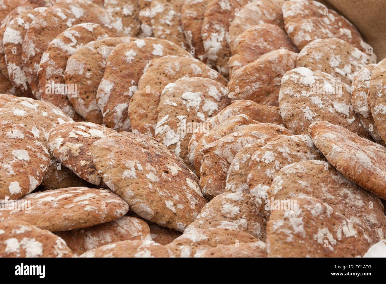 Tradizionale farina di segale pane cotto sul sito durante la 'Speckfest' celebrazione in Val di Funes, Dolomiti. Foto Stock