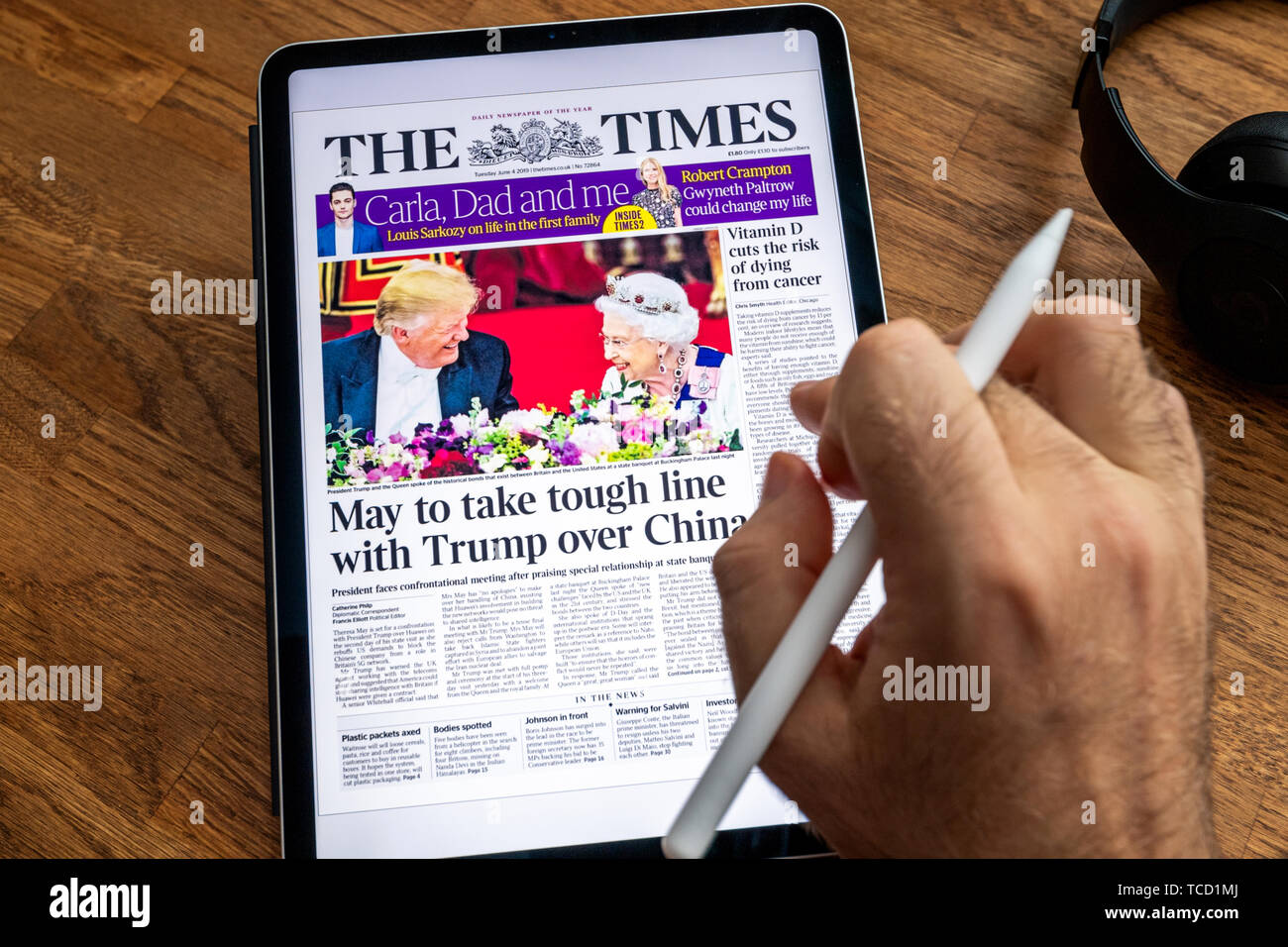 Parigi, Francia - giu 6, 2019: uomo lettura su iPad Apple Pro Times su Donald Trump negli Stati Uniti visite presidenziali per il Regno Unito e l'Irlanda incontro la regina Foto Stock