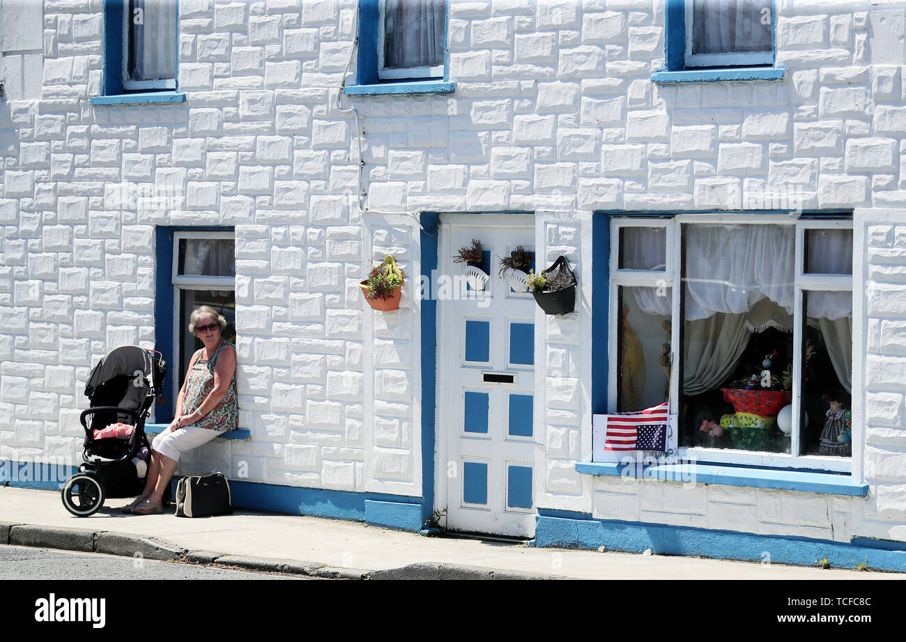 Una donna si trova nel villaggio di Doonbeg, County Clare, davanti a noi il presidente Donald Trump la partenza per l'aeroporto di Shannon. Foto Stock