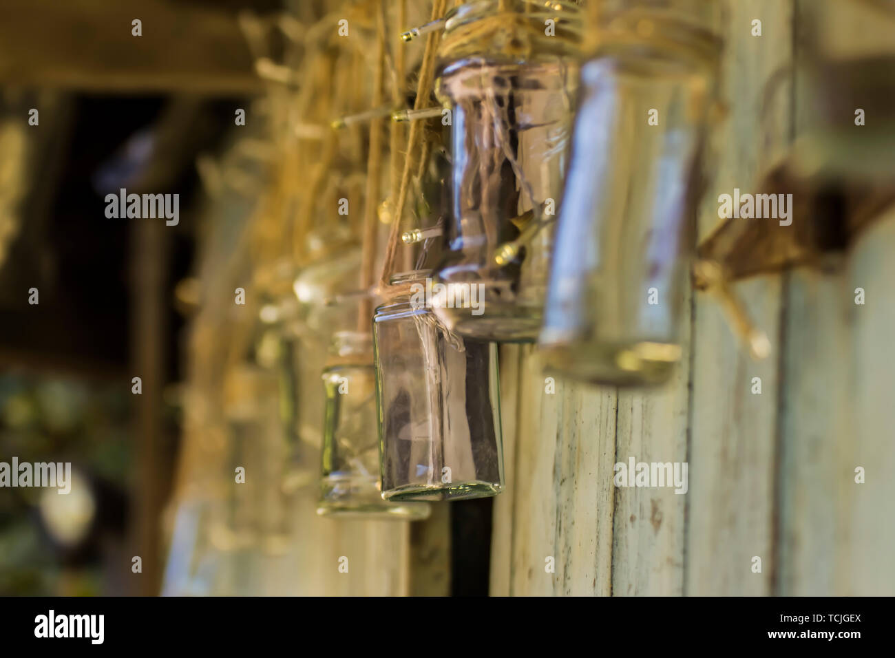 Sporco vasetti di vetro al di fuori di un marciume sparso con luci led acceso per dare ambiance. Foto Stock