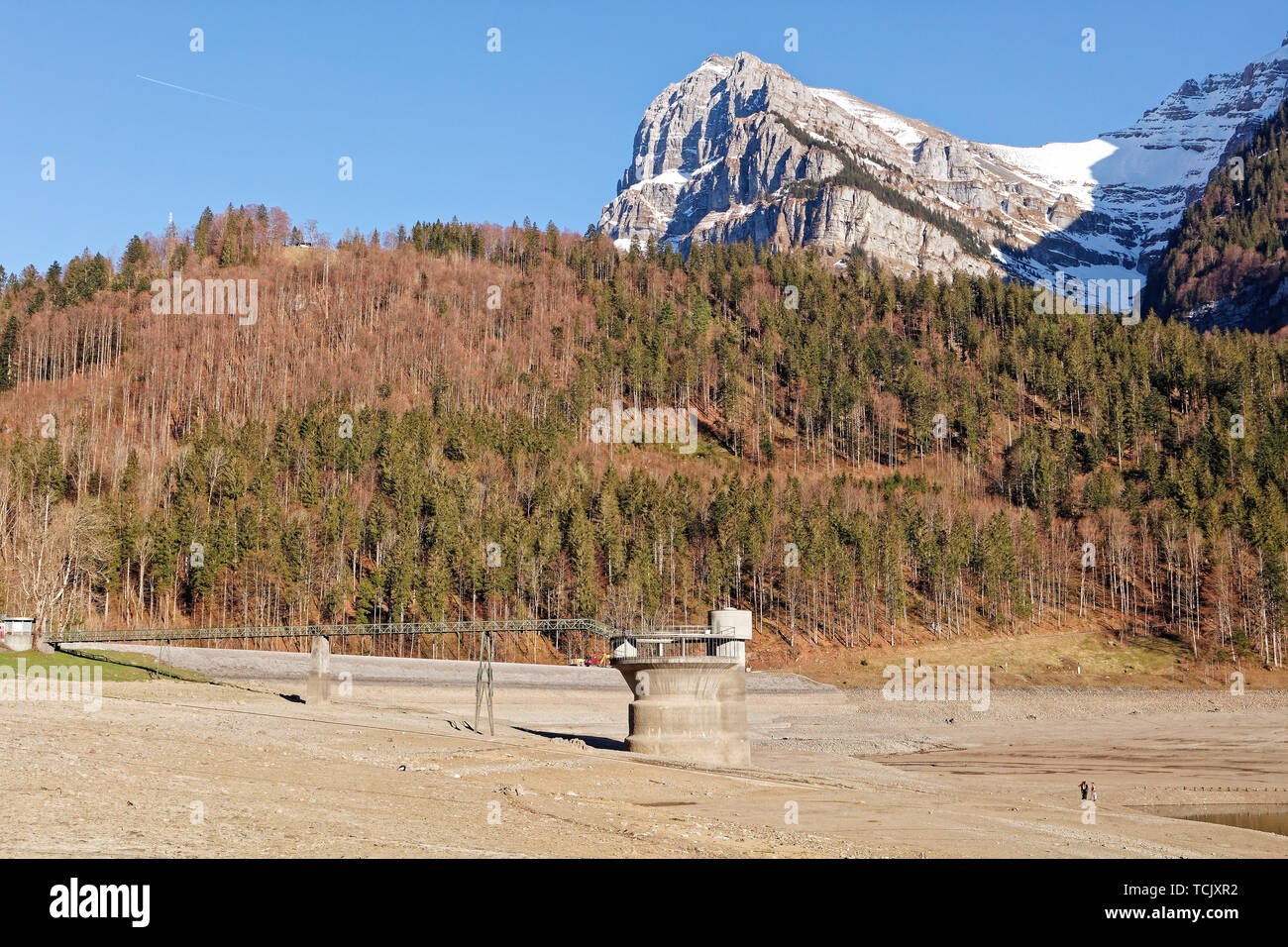 La gente che camminava sul fondo asciutto del lago del Klöntal lago del Klöntal (Kloental valley) - Seerüti (Seerueti), Svitto Alpi, kanton Glarus, Svizzera Foto Stock