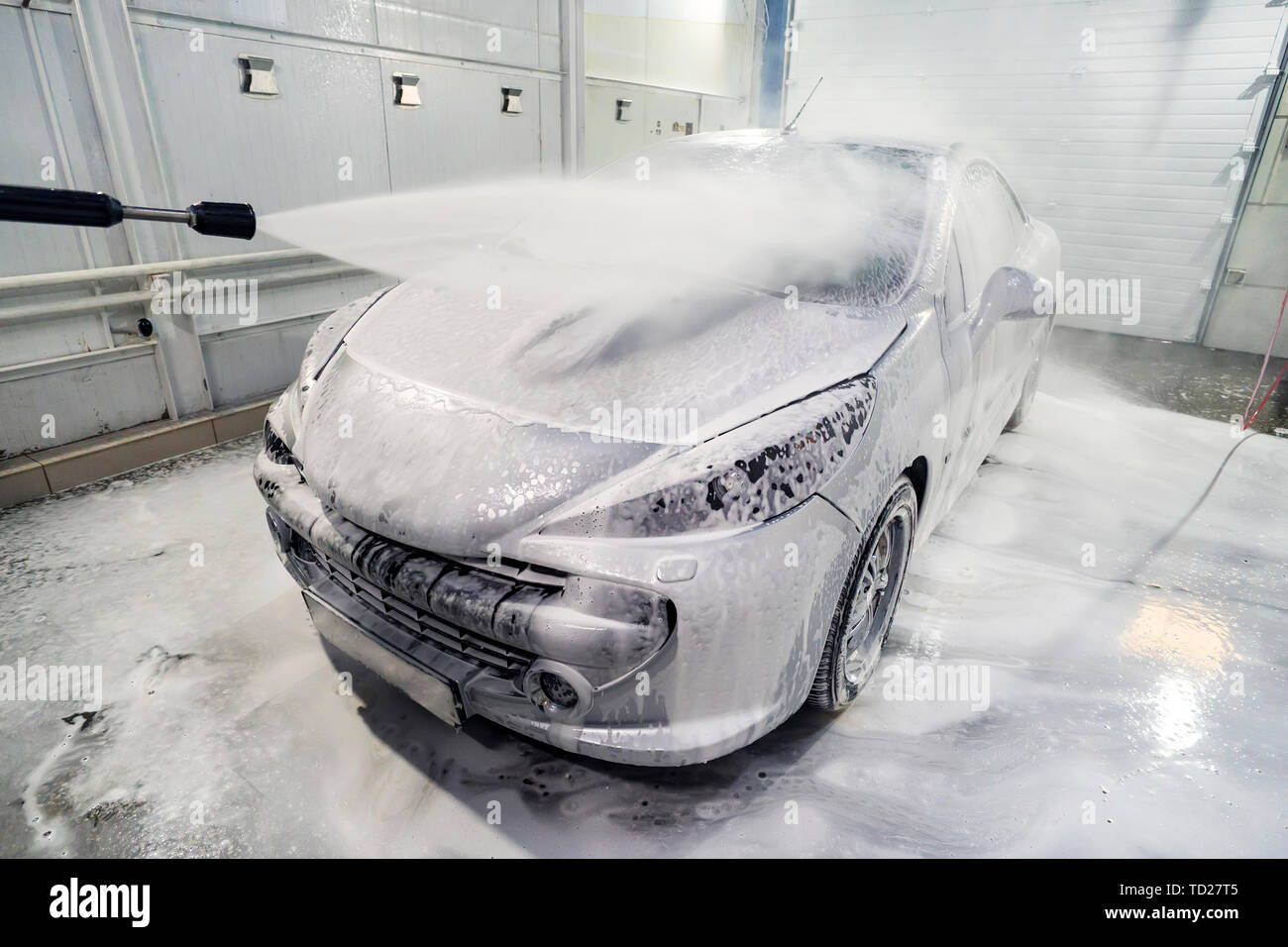 Auto è ricoperta di schiuma per lavare la macchina. Stazione di lavaggio  automatico. Shampoo per auto. Il processo di pulitura. self-service Foto  stock - Alamy