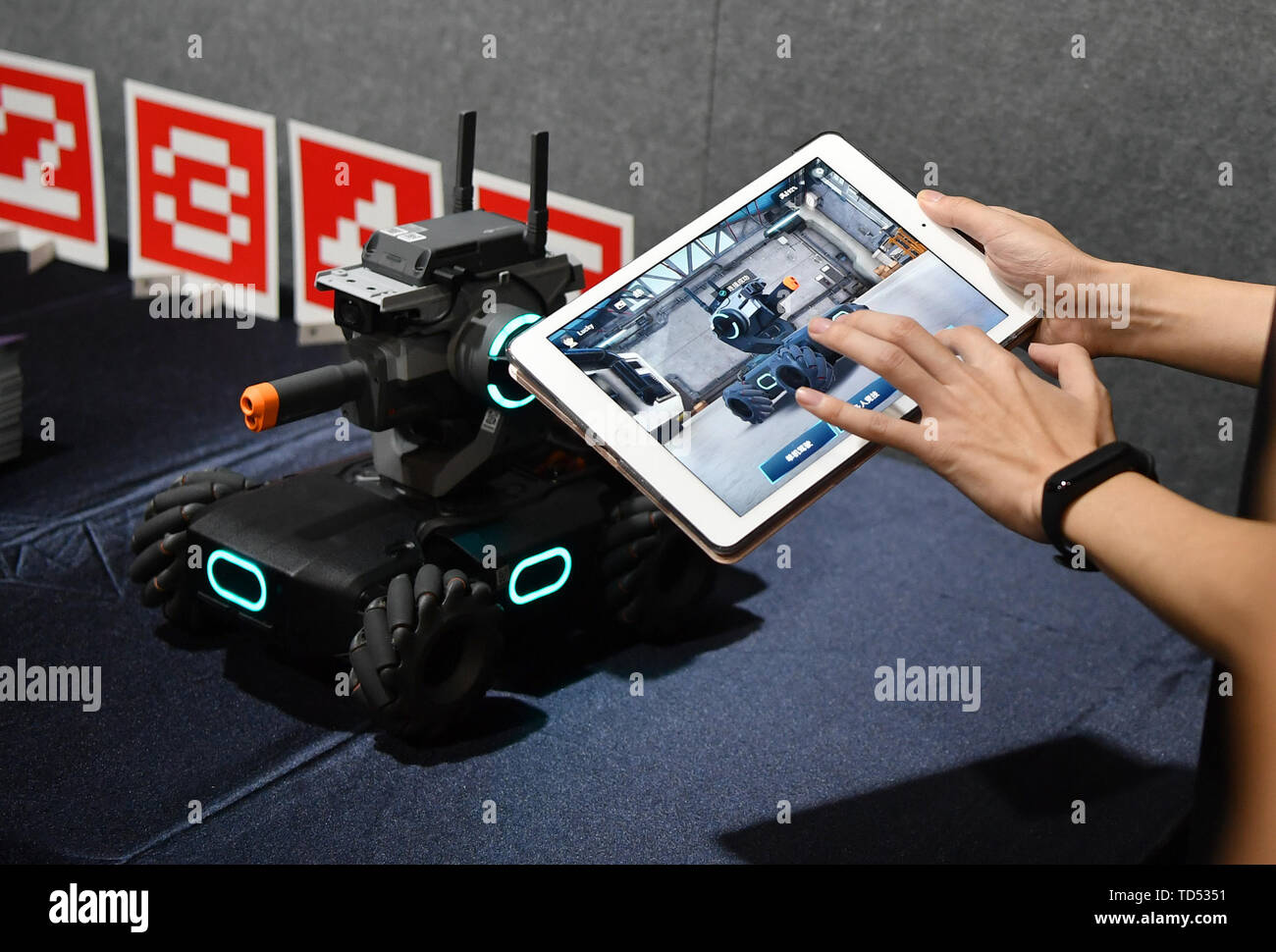 Pechino, Cina. 12 Giugno, 2019. Un membro del personale dimostra un robot educative prodotte dai cinesi drone maker DJI in corrispondenza di un evento a Pechino Capitale della Cina, 12 giugno 2019. DJI ha lanciato il suo primo robot educativo RoboMaster S1 in corrispondenza di un evento di mercoledì. Il robot 2 di supporto dei linguaggi di programmazione, dispone di una configurazione dei sensori 31 e 46 i componenti programmabili. Credito: Wang Qingqin/Xinhua/Alamy Live News Foto Stock