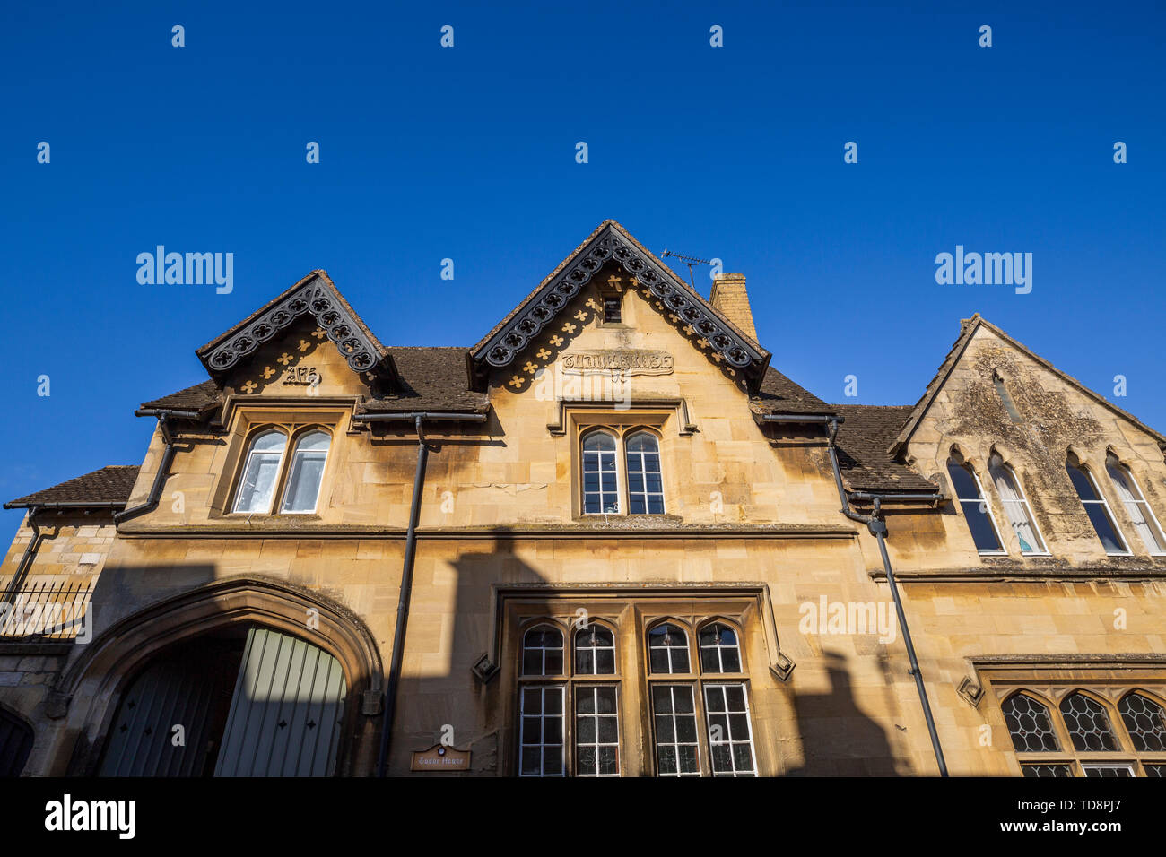 Tudor House nelle strette strade di Winchcombe con l'ombra delle ciminiere delle case oppsosite Foto Stock