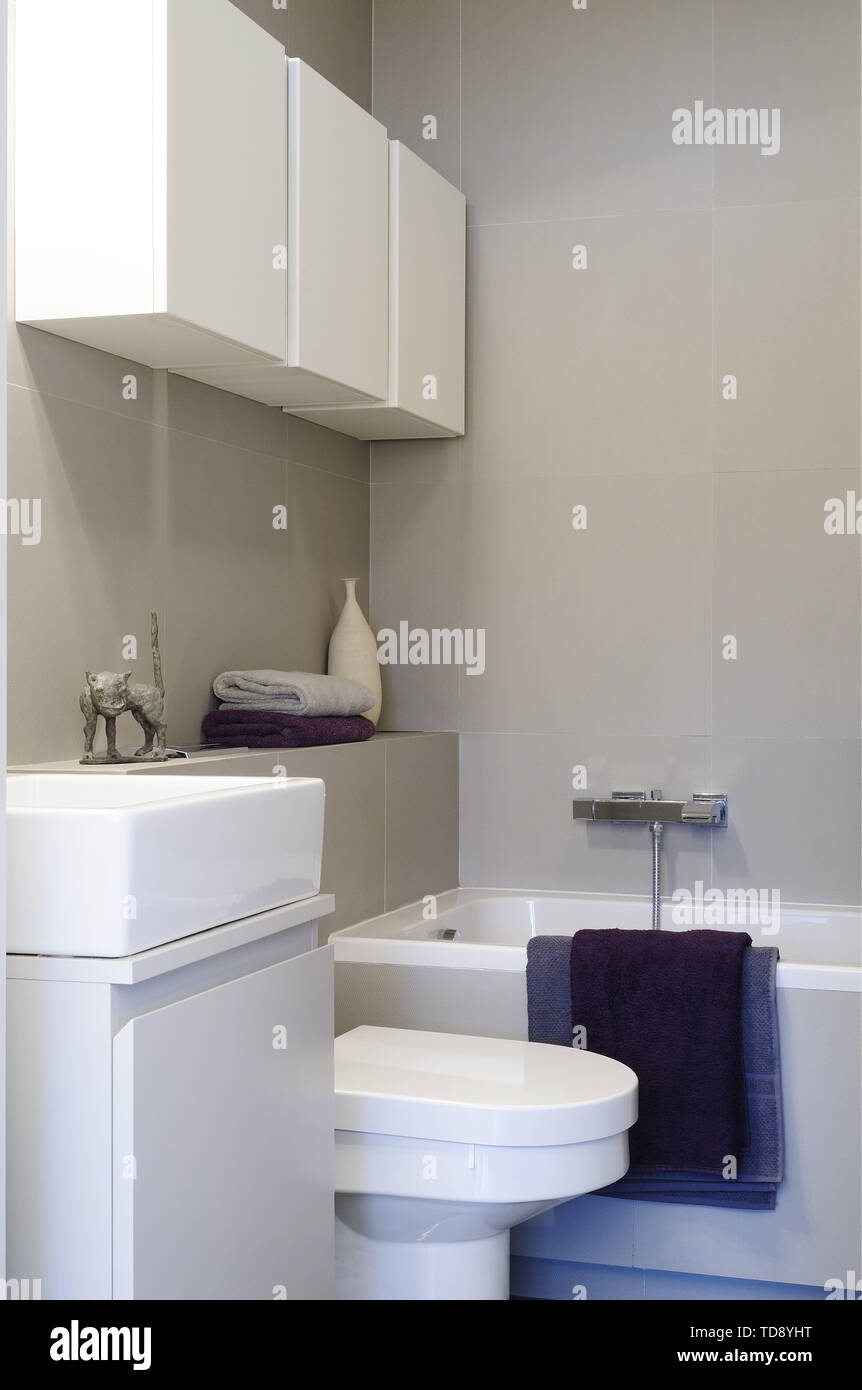 Violetta asciugamani posato sul bordo vasca in bagno minimalista UK & IRISH UTILIZZARE SOLO Foto Stock
