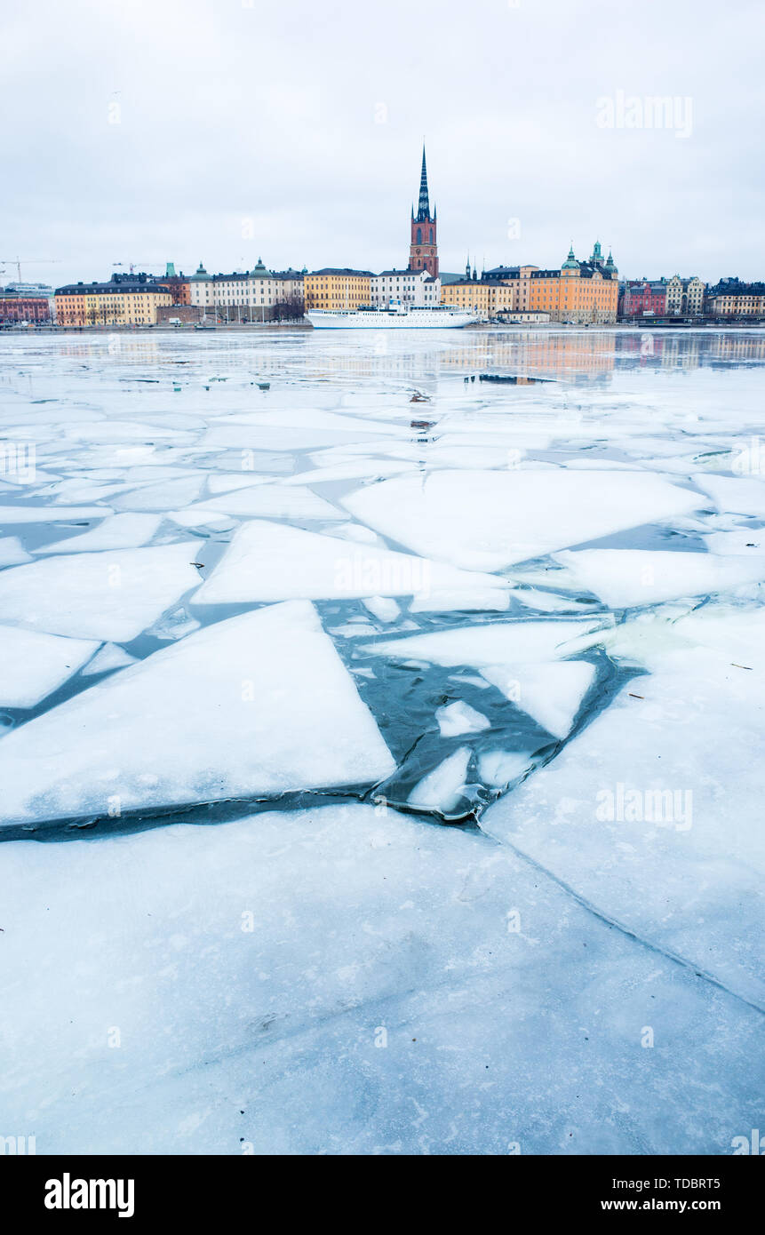 Vista invernale di Stoccolma la città vecchia, Gamla Stan e CHIESA DI RIDDARHOLM, con barche ormeggiate nel lago ghiacciato che conduce al Mar Baltico. Foto Stock