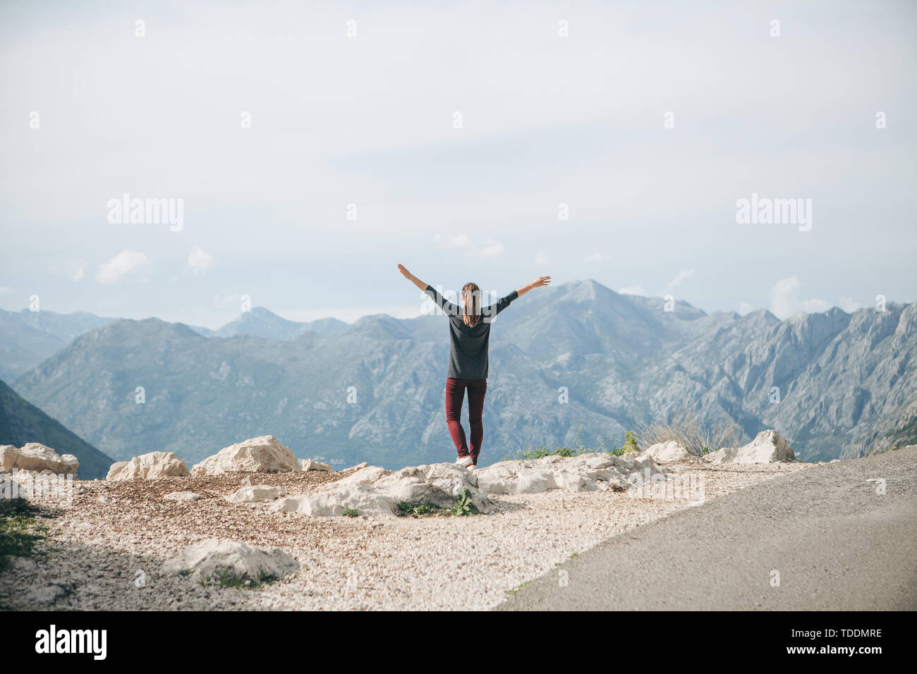 Ragazza sulla cima di una montagna o collina alza le mani verso l'alto. Lei  è felice e libera Foto stock - Alamy