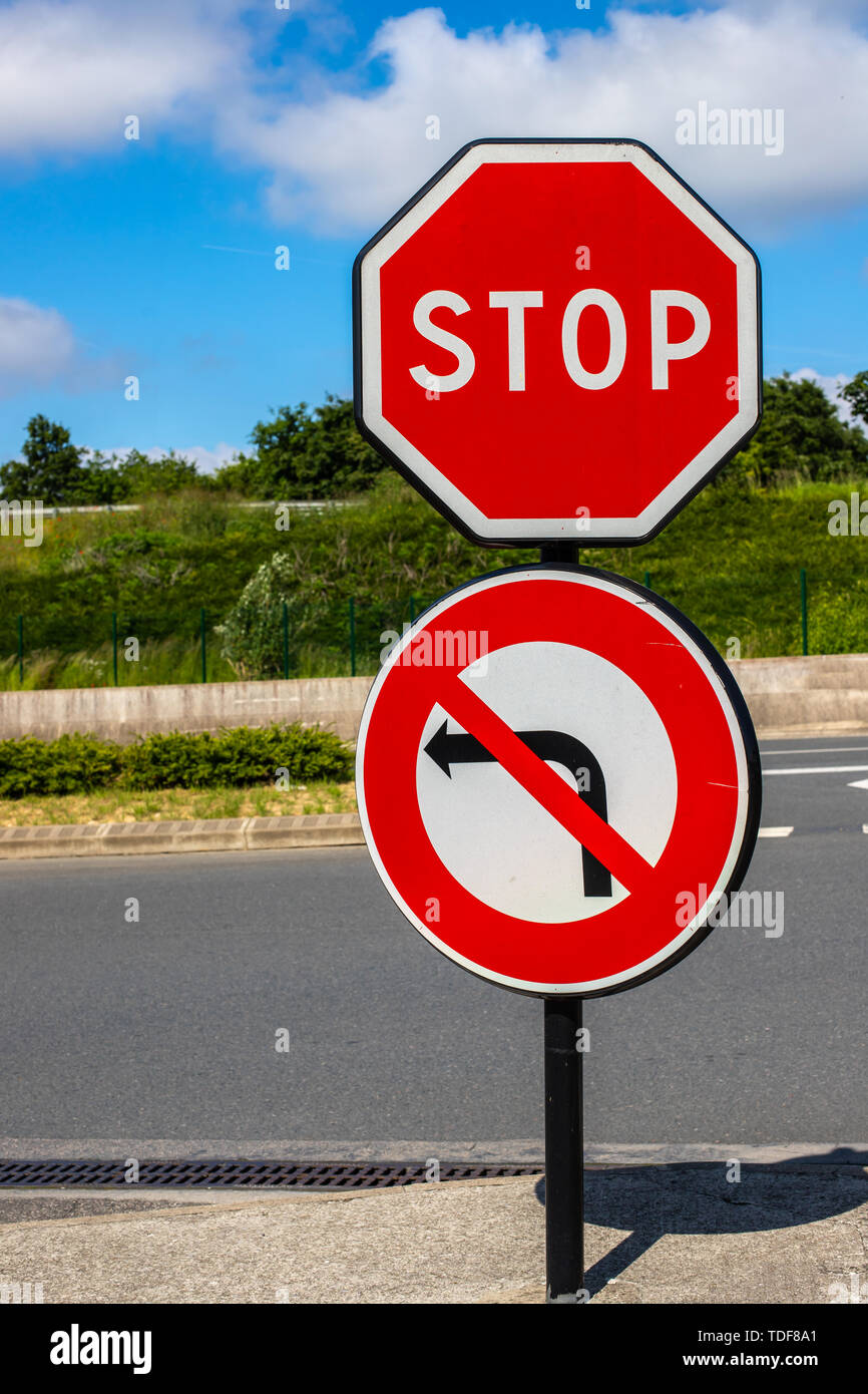 Smettere di segno di traffico non svoltare a sinistra. Restrizione del traffico contro lo sfondo della strada e il cielo luminoso Foto Stock