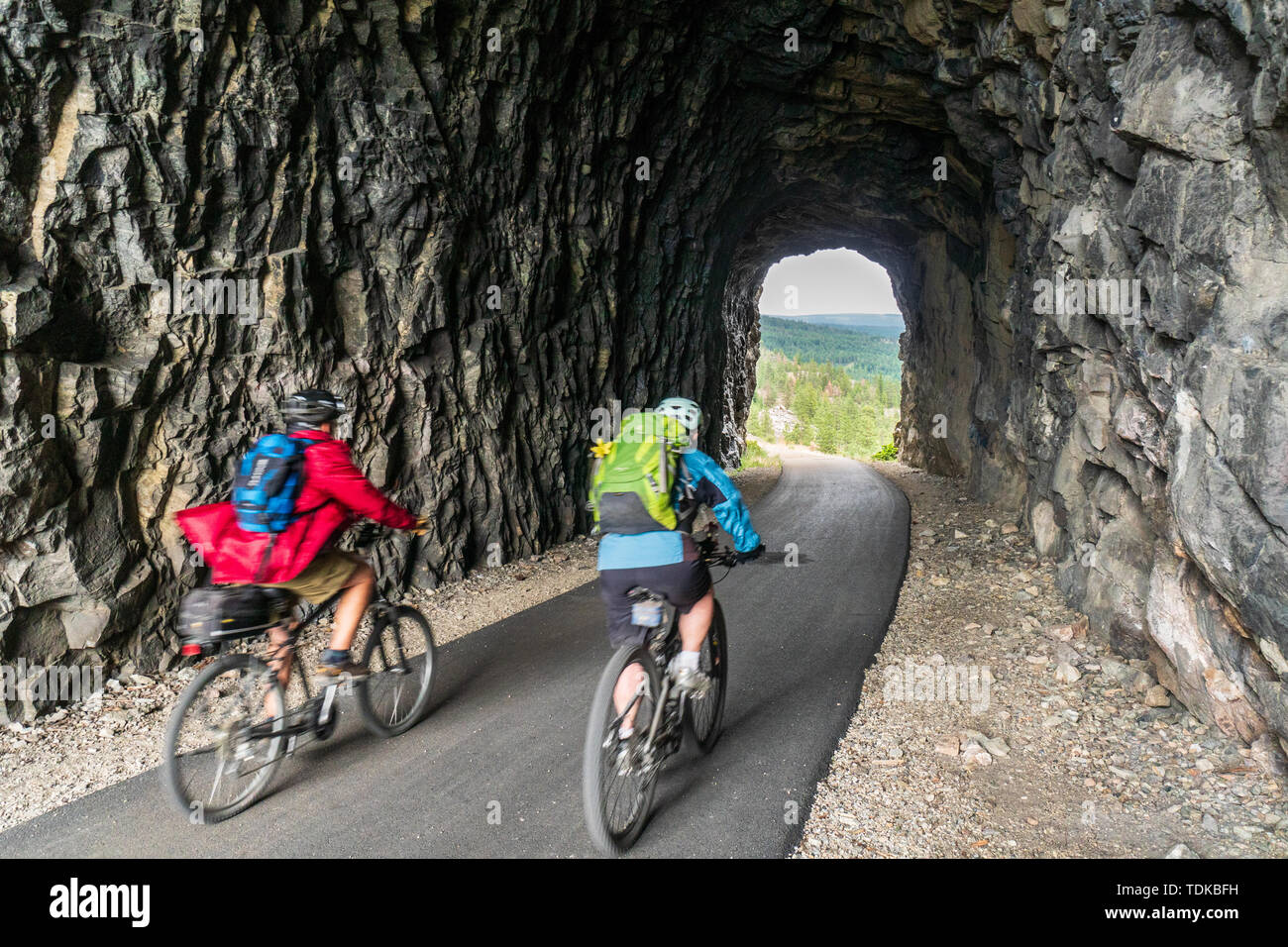 Matura in bicicletta in uno dei tunnel del bollitore Valley Railway (KVR) una ferrovia abbandonata convertito ad un escursionismo/mountain bike trail. Foto Stock