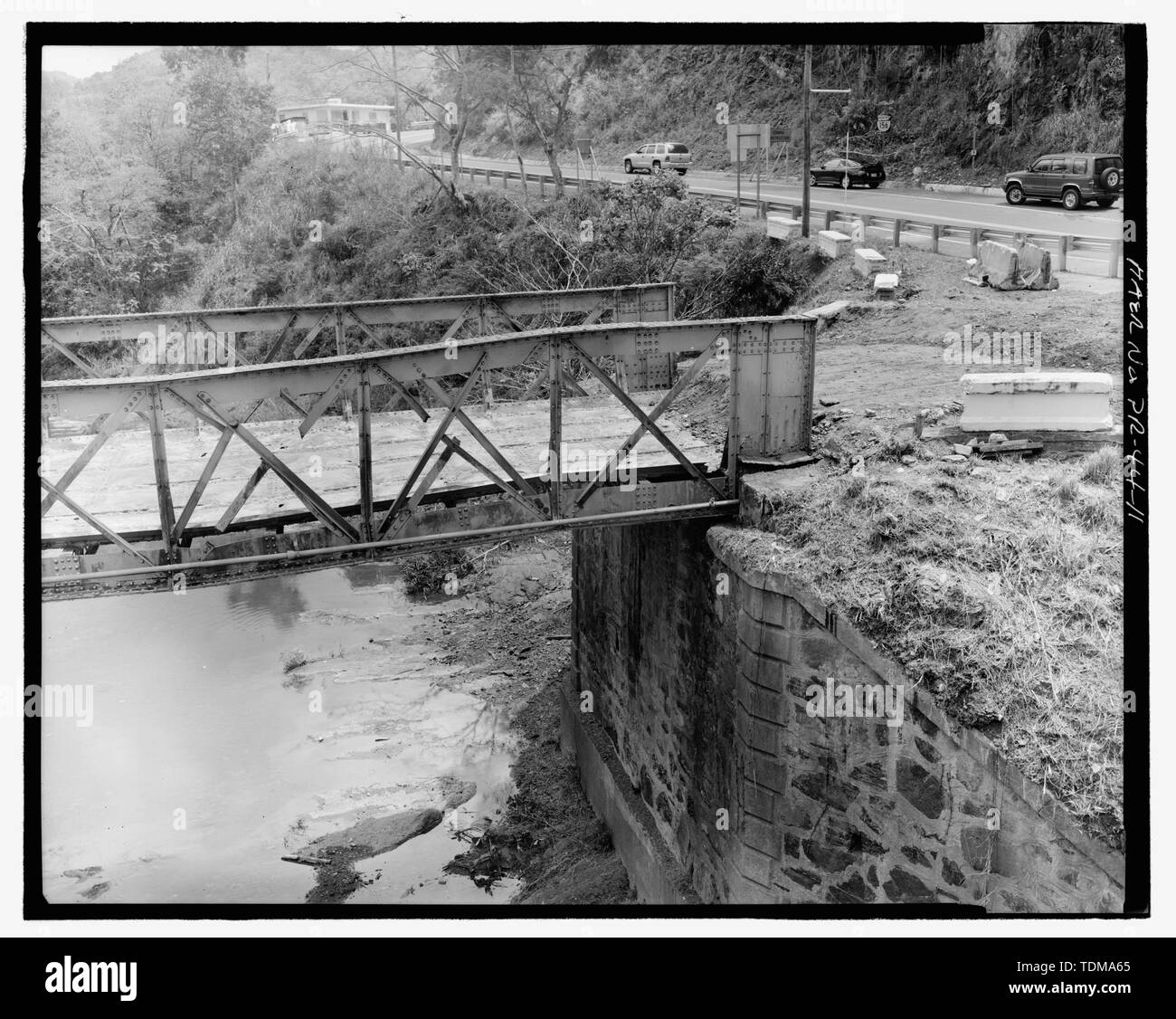 Parziale vista obliqua del lato occidentale dell'estremità sud dal ponte nuovo. - Puente Rio Hondo, Spanning Hondo Fiume sulla strada PR 156, Barrio Rio Hondo, Comerio, Comerio Municipio, PR; De Campos, Miguel Martinez; Belge, Belgio; Nones, Rafael; Hill, E H; Calloway, Debora, trasmettitore; Pumarada-O'Neill, Luis, storico Foto Stock