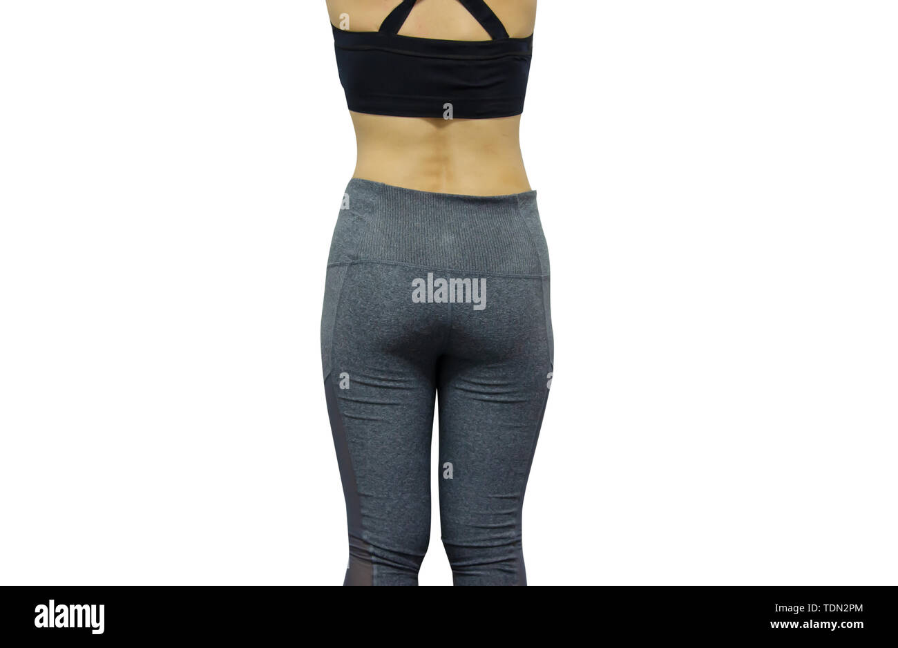 Donne che indossano vestiti di esercizio, in piedi tenendo la vita su uno sfondo bianco. Foto Stock