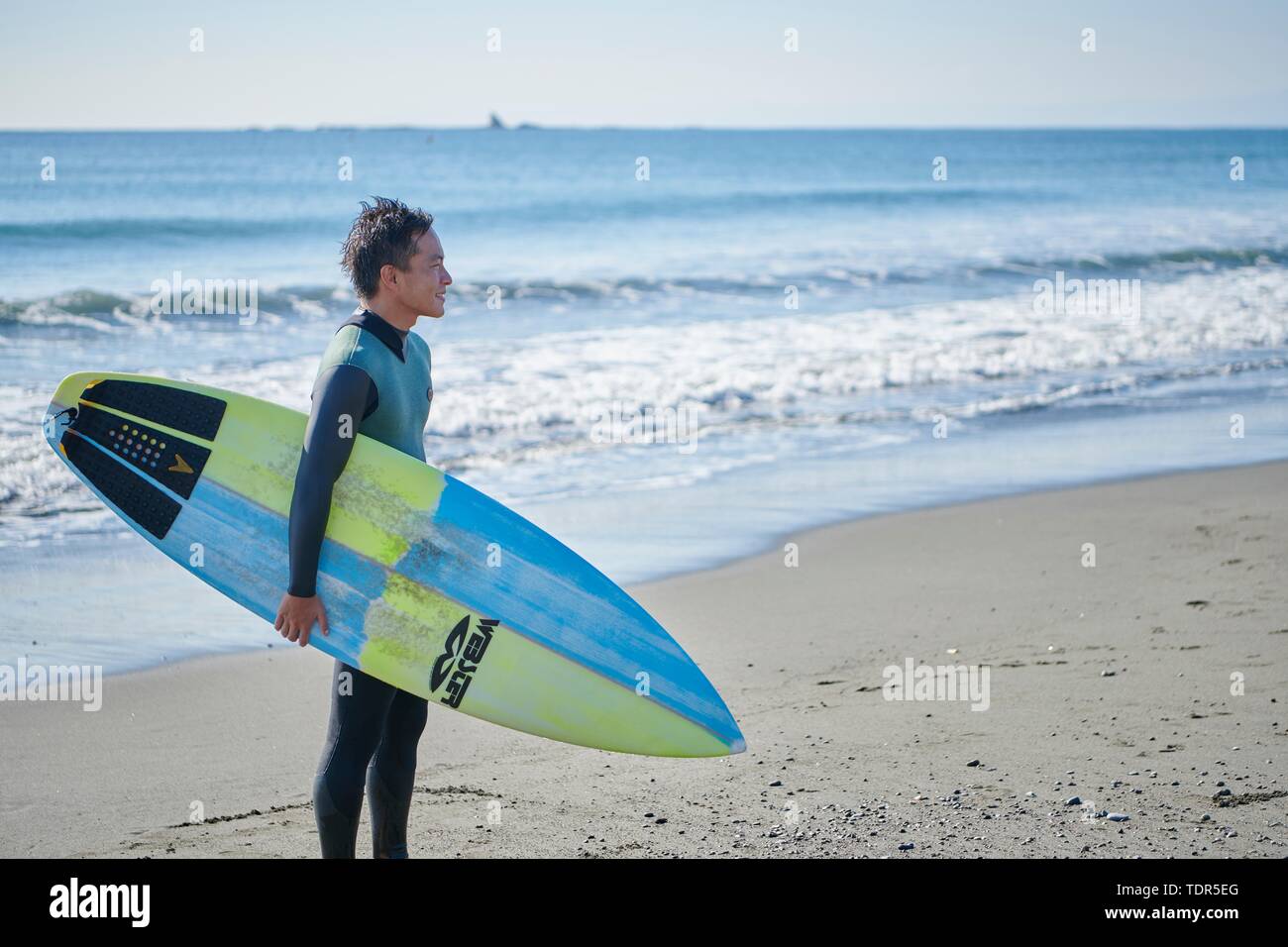 Surfista giapponese presso la spiaggia Foto Stock