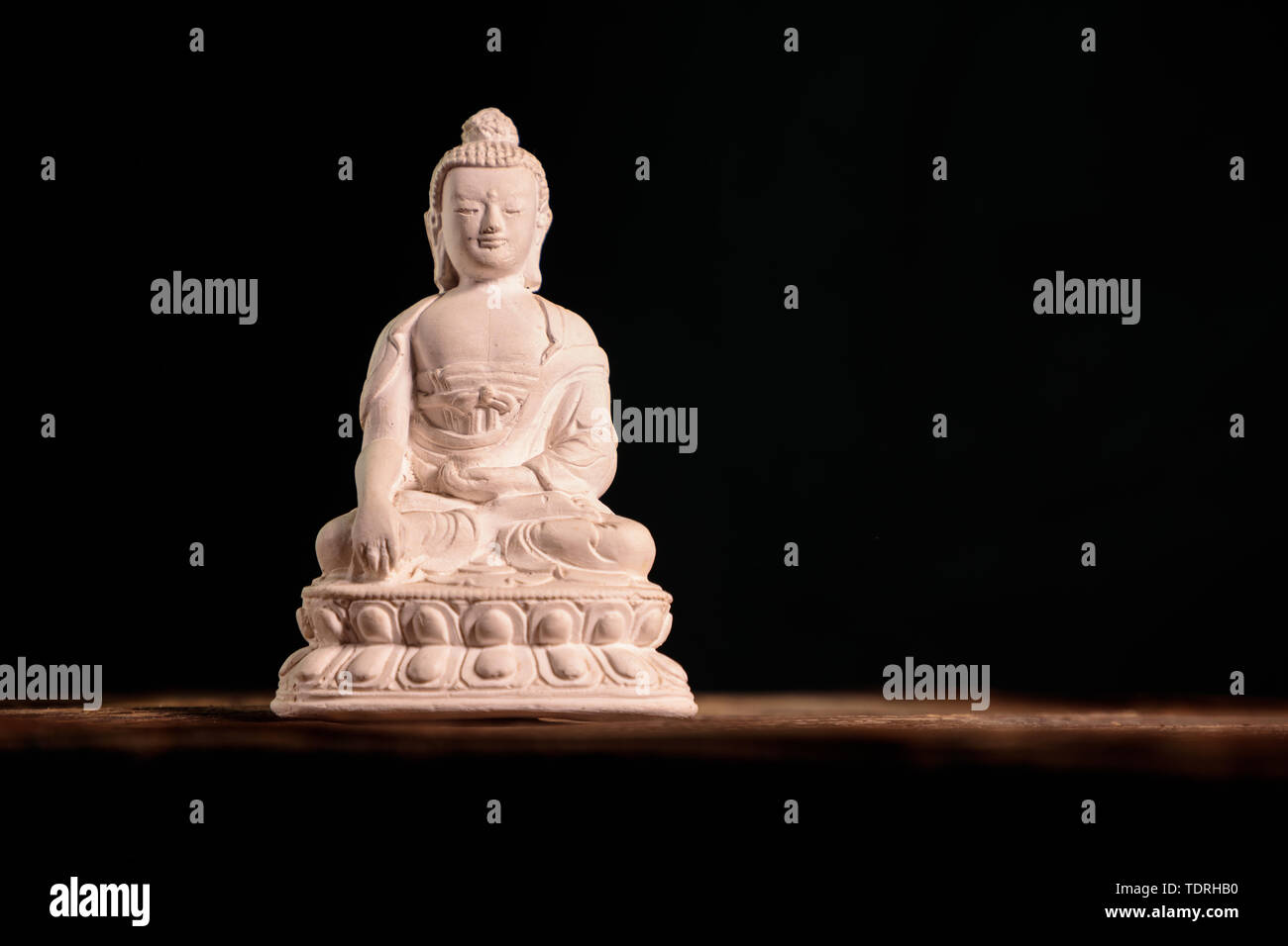 Figurina bianca del buddha di fossili di Foto Stock