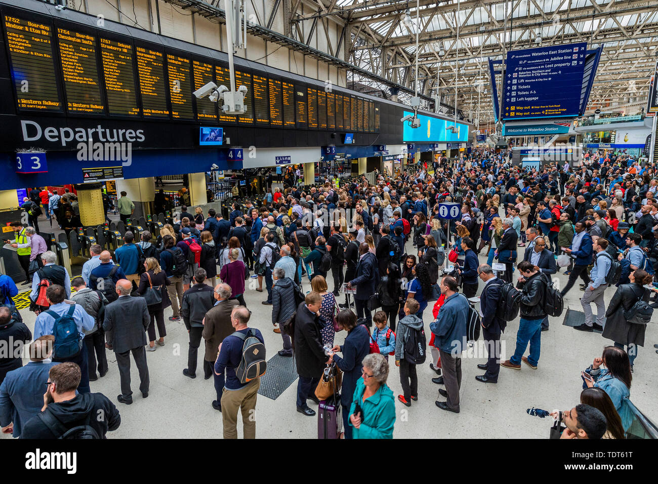 Londra, Regno Unito. Il 18 giugno, 2019. La folla costruire fino a causa di un servizio ridotto a causa dello sciopero dei RMT personale su SW convogli ferroviari, e sono più pesanti al Suburban commuter fine dell'atrio. Passeggeri attendere notizie dei propri treni sul piazzale della Stazione Waterloo di Londra. Credito: Guy Bell/Alamy Live News Foto Stock