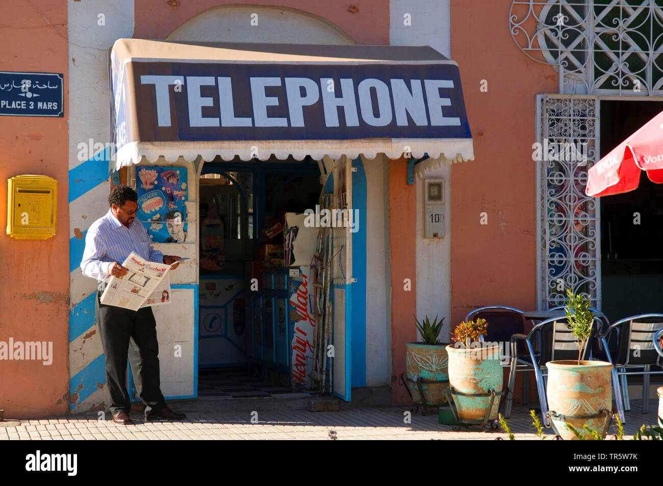 Telefono shop in Ouarzazate, uomo leggendo un giornale, Marocco Ouarzazate Foto Stock
