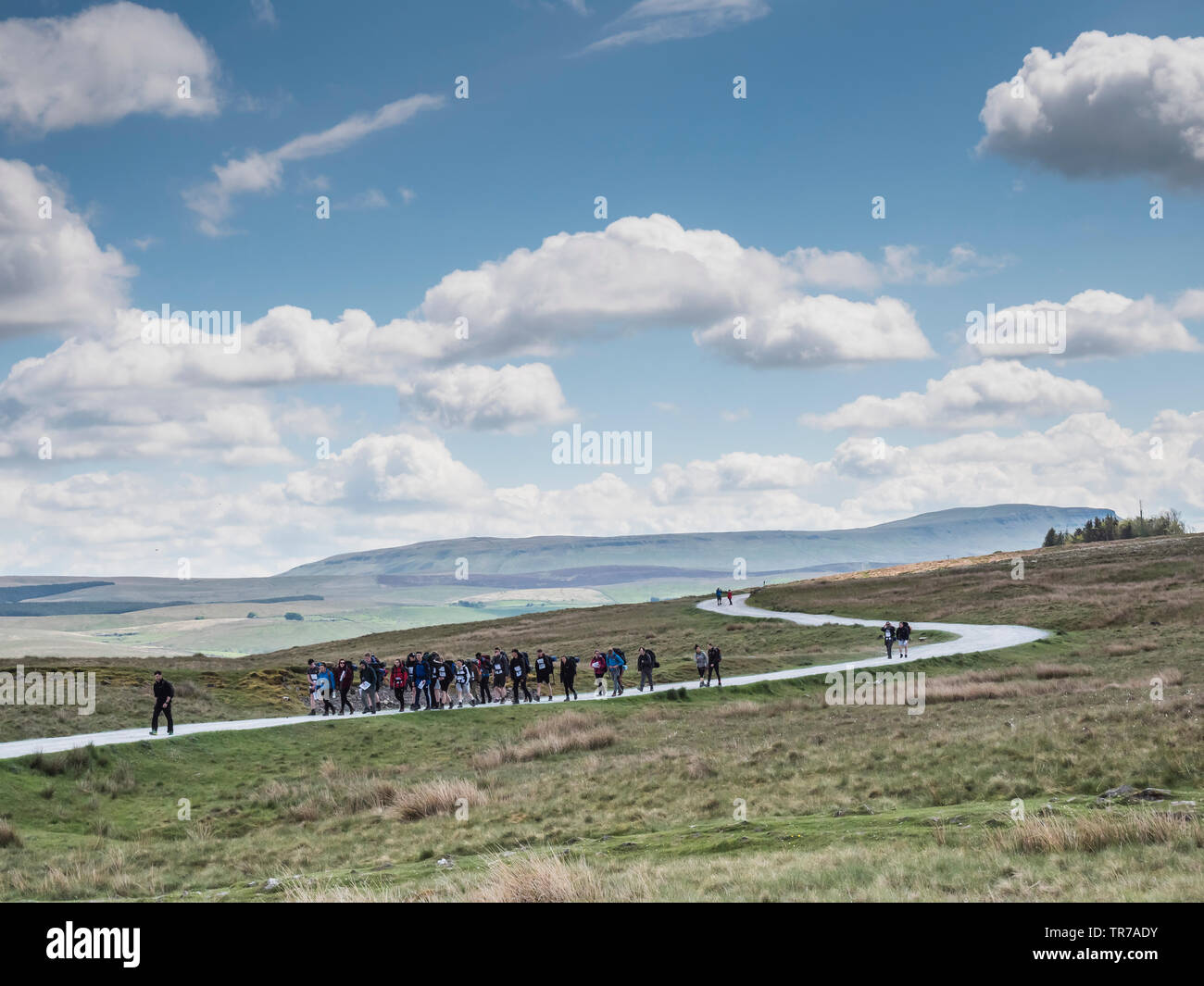 Un gruppo di adolescenti di impresa del Duca di Ediburgh del regime di premio per il montaggio sulla pista vicino al Ribblehead attraverso il condotto in Yorkshire Dales Foto Stock