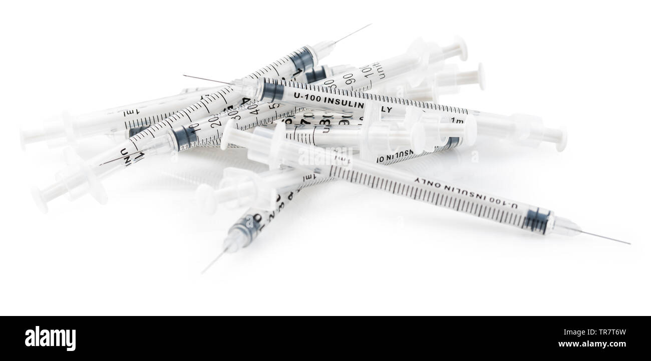 Pila di siringhe usate per insulina isolati su sfondo bianco Foto Stock