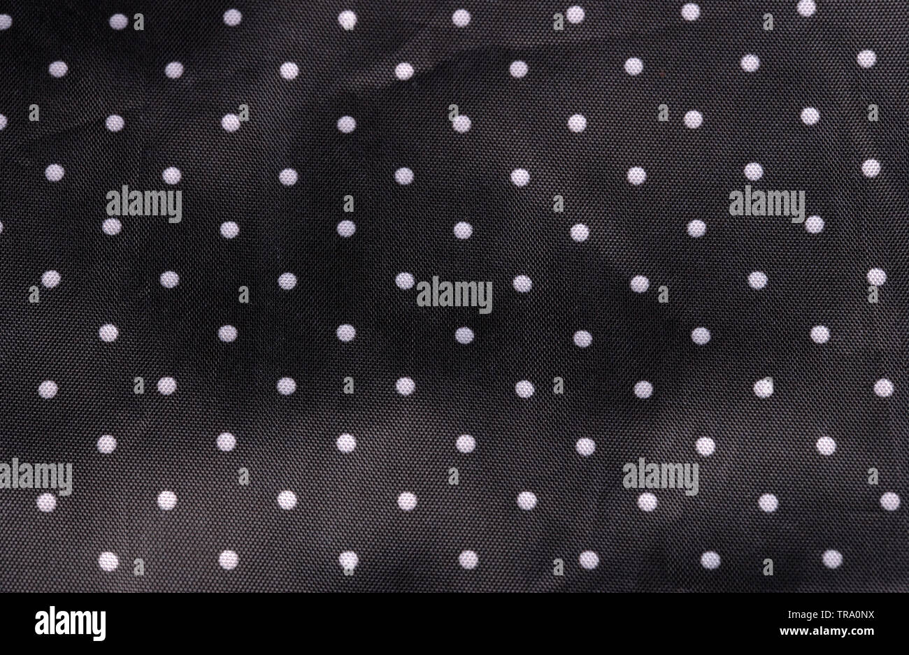 Tessuto nero lo sfondo con puntini bianchi Foto Stock