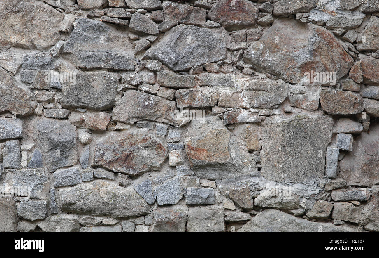Texture medievale di pietre di campo di un muro di fortificazione Foto Stock