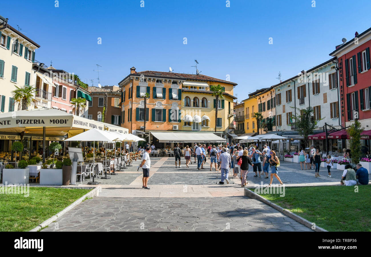 SIRMIONE SUL LAGO DI GARDA, Italia - Settembre 2018: persone in piazza vicino al porto di Sirmione sul Lago di Garda. Intorno alla piazza sono i ristoranti Foto Stock