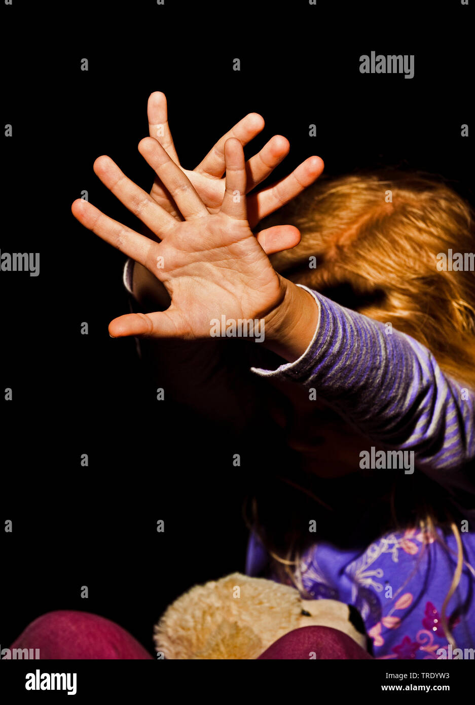 Ritratto di una giovane ragazza outstreching le braccia per la protezione - abuso di minori Foto Stock
