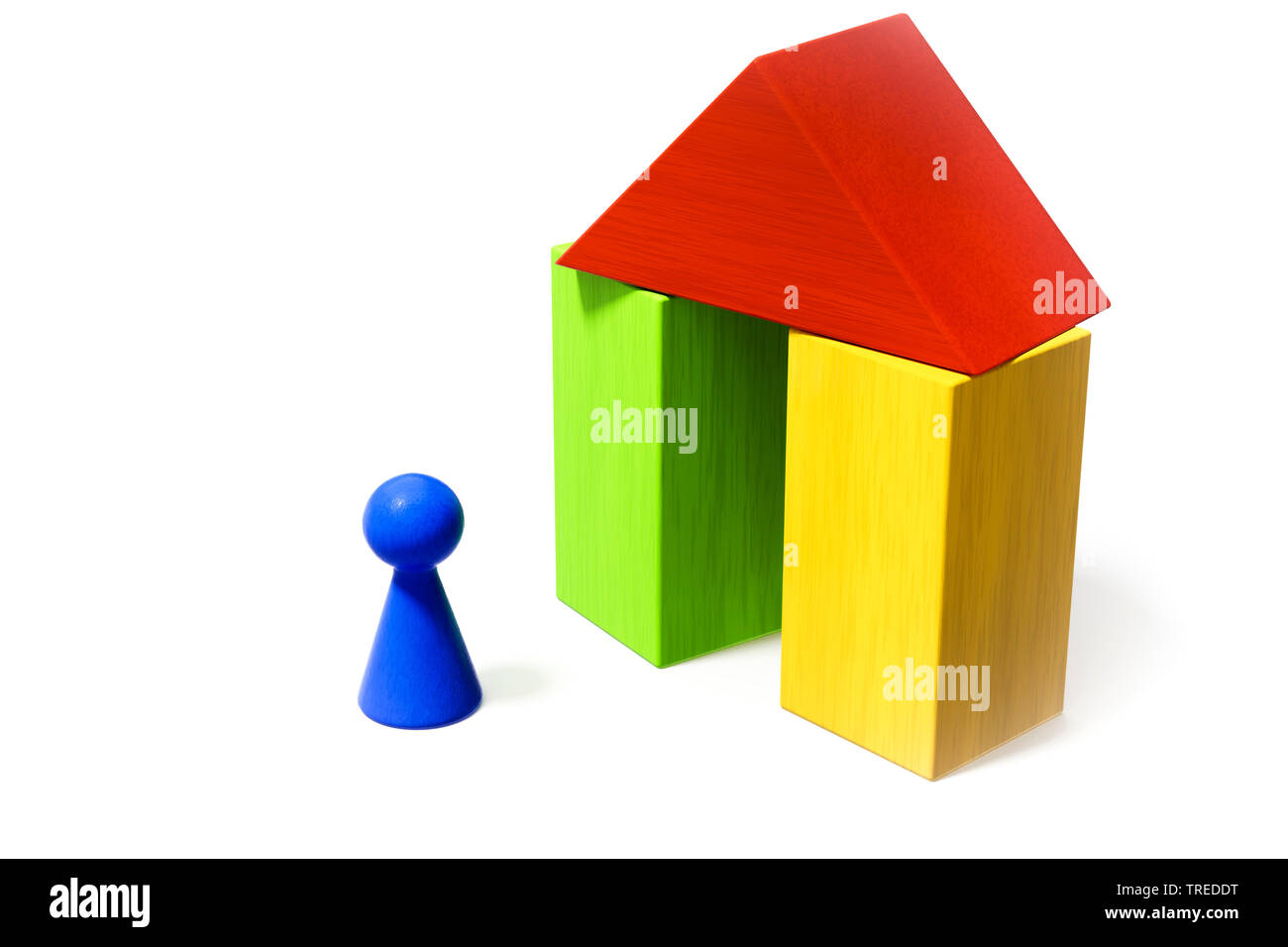 Una pedina blu nella parte anteriore di un giocattolo di casa costruita in mattoni in legno Foto Stock