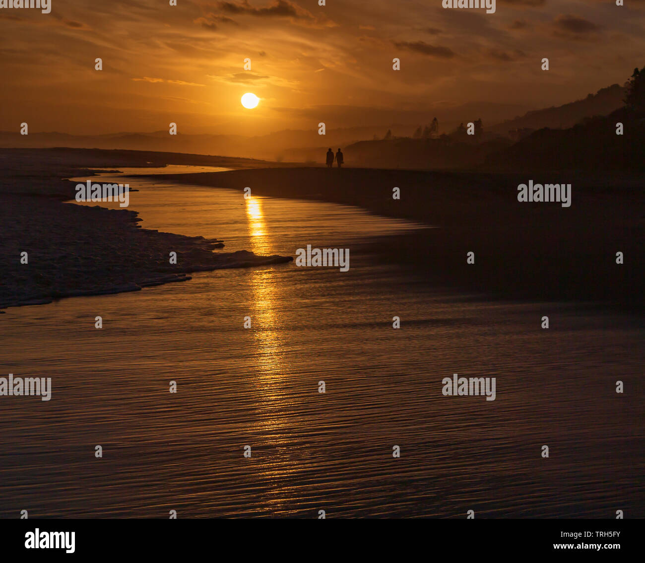Tramonto a Glentana beach con il riflesso del sole sulla sabbia bagnata, Provincia del Capo Occidentale, Sud Africa Foto Stock