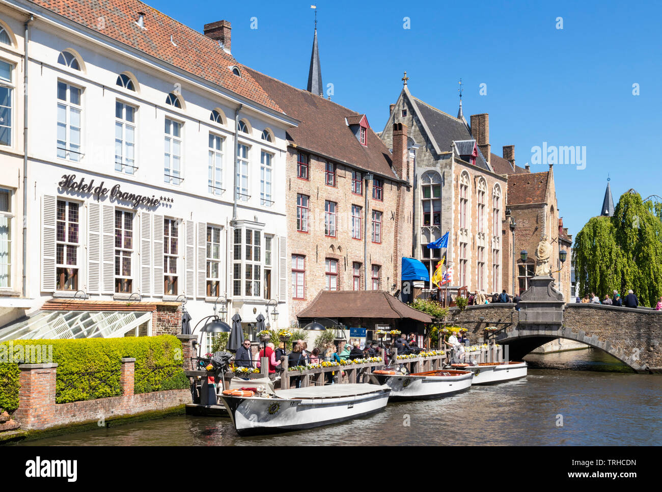Gite in barca dal pontile sul Den Dijver canal di fronte all'Hotel De Orangerie un quattrocentesco ex convento in Bruges Belgio UE Europa Foto Stock