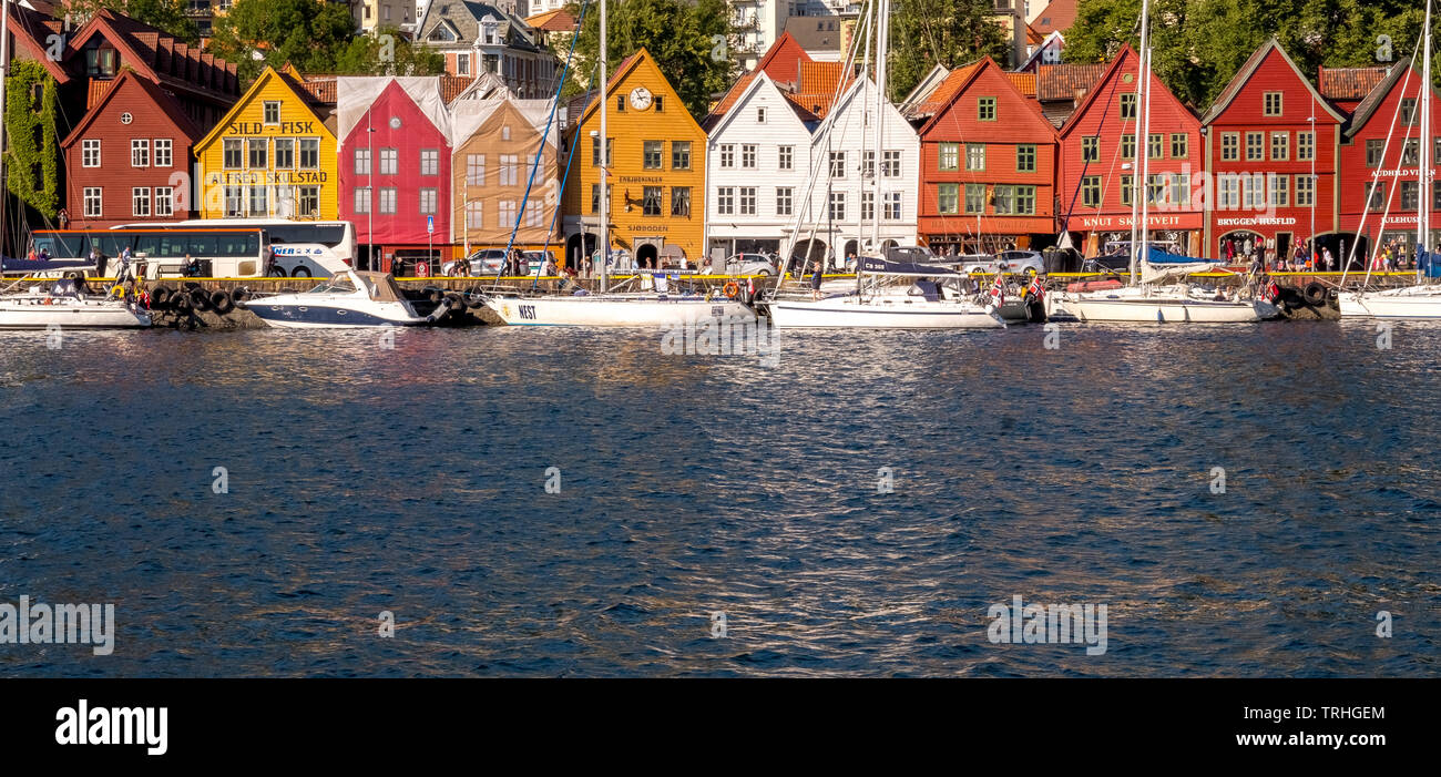 Mare del Nord, dietro un colorato case di legno davanti con attaccato velieri nel porto di Bryggen, Bergen Hordaland, Norvegia, Scandinavia, Europa, né Foto Stock