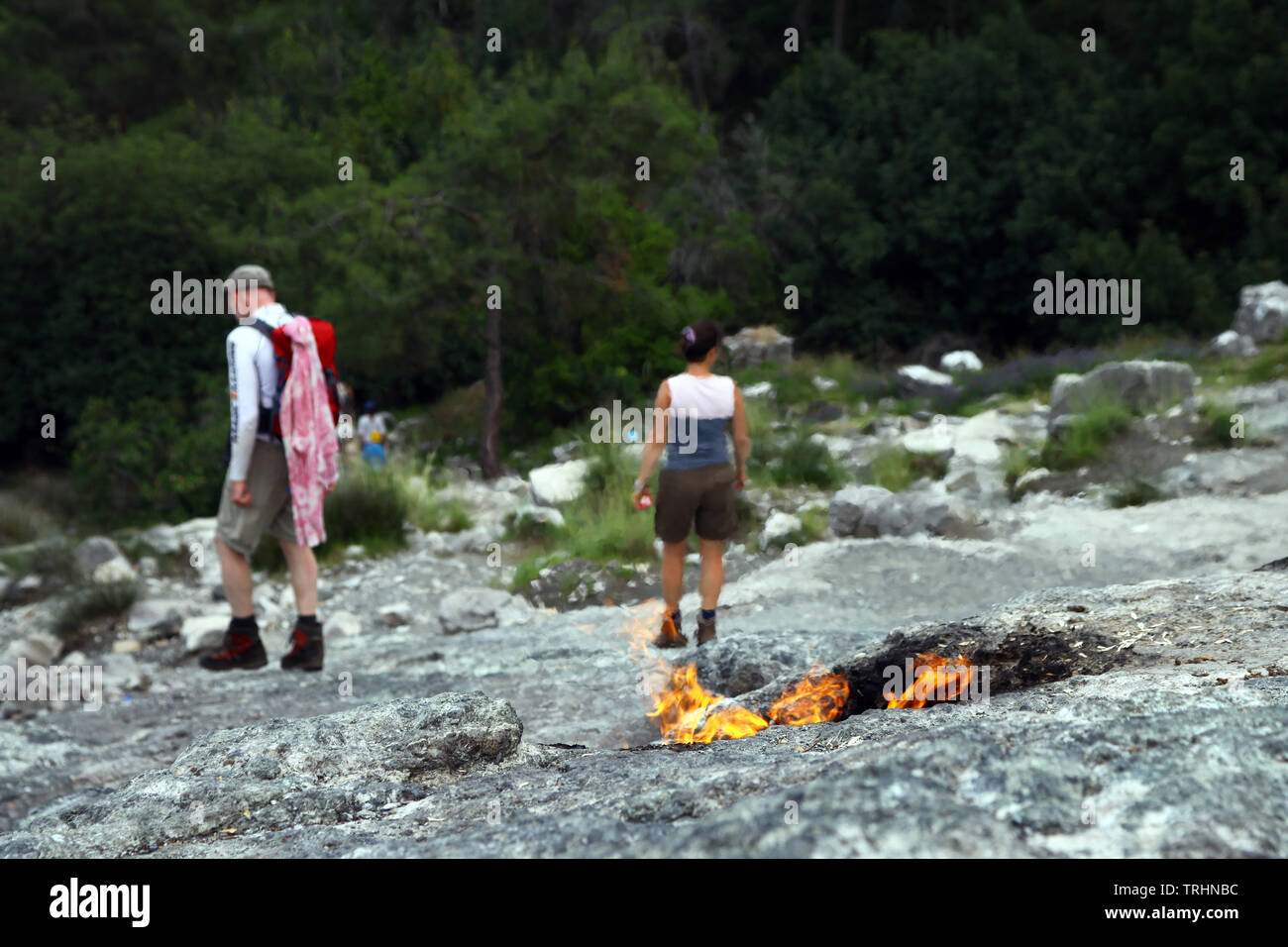 Turisti stanno visitando flaming rock (Yanartas) sulla montagna di Chimera in Cirali, Antalya Foto Stock