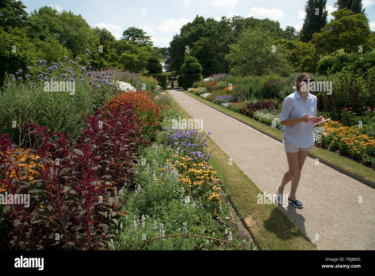Gli ospiti godono di vista i due bordi della parete Giardino a Nymans, West Sussex Foto Stock