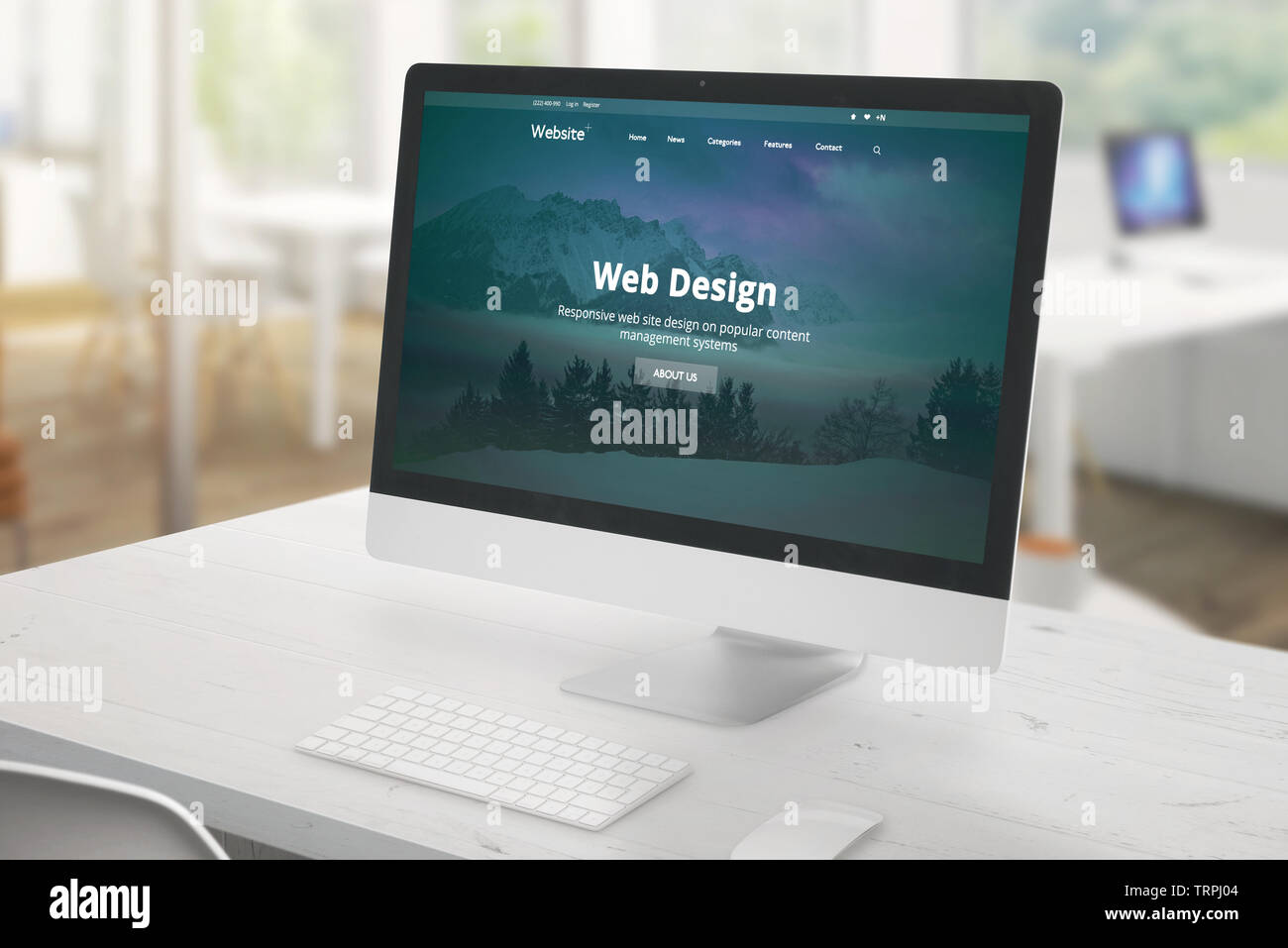 Monitor da studio con web design studio presentazione. Scrivania bianca con tastiera e mouse. Ufficio in background. Foto Stock