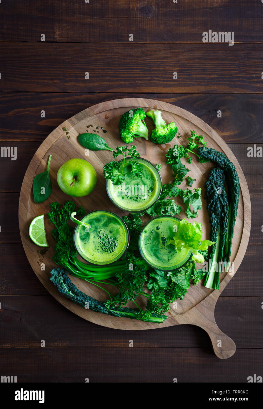 Vista aerea del fresco succo verde al buio su un superficie di legno con spazio di copia Foto Stock