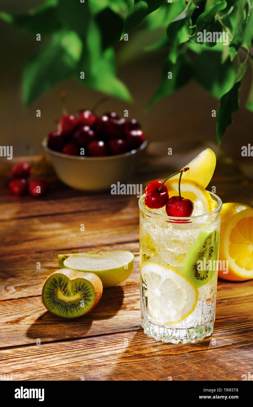 Apple a freddo e kiwi limonata sul tavolo in giardino nella luce del sole di mattina Foto Stock